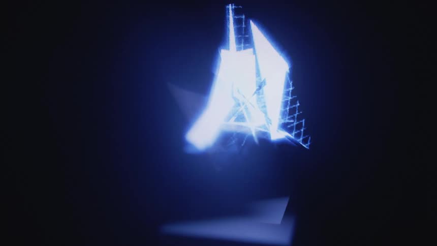 A line animation in the shape of a stack of boxes plays on a screen