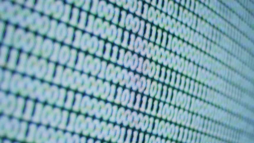 A monitor showing ones and zeros