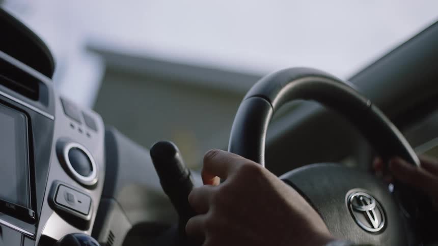 Woman drives car turning the steering wheel