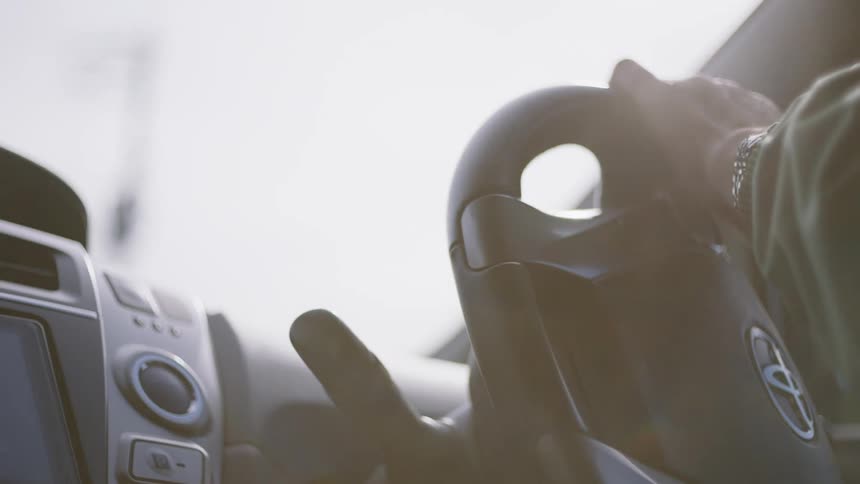 Interior view of person driving a toyota vehicle