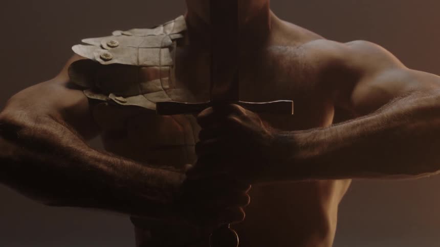 A man lifts a sword up