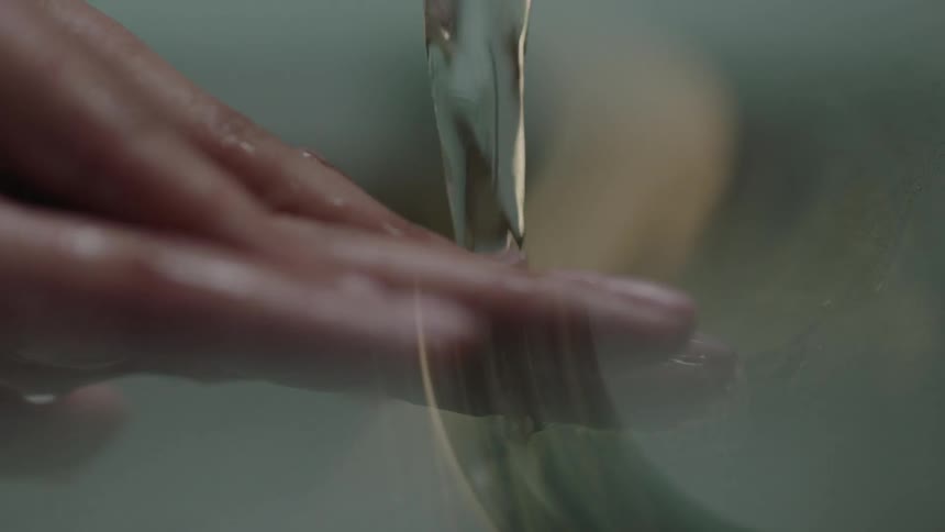 A person washes their hands