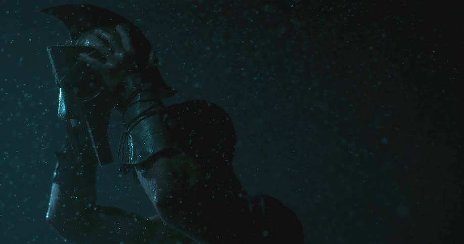 A man puts on his helmet in the rain