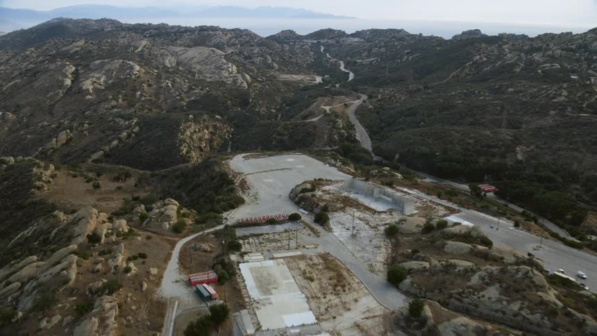  aerial footage flying over the Rocketdyne aerospace testing facility in Brandeis California on a cloudy day
