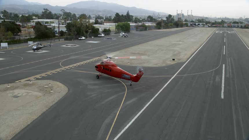 Tracking the Sikorsky S58T helicopter as it moves on the runway of Whiteman Airport in Pacoima California during a summer day