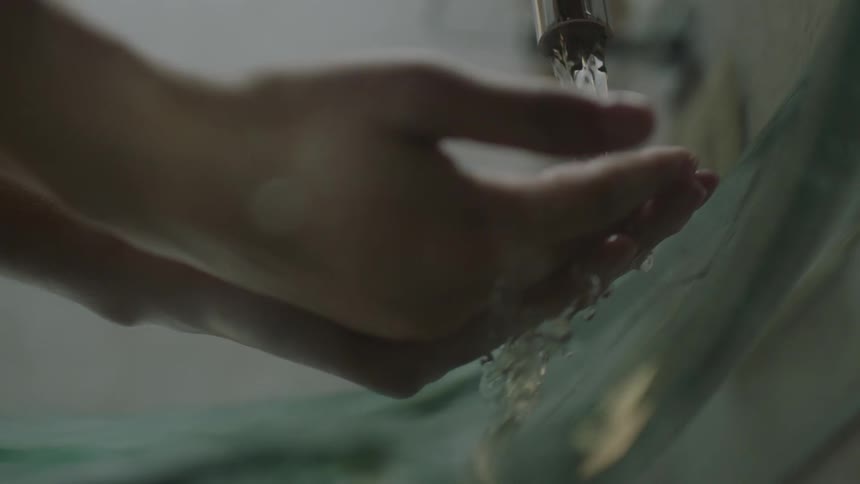 A person puts their hands under the water