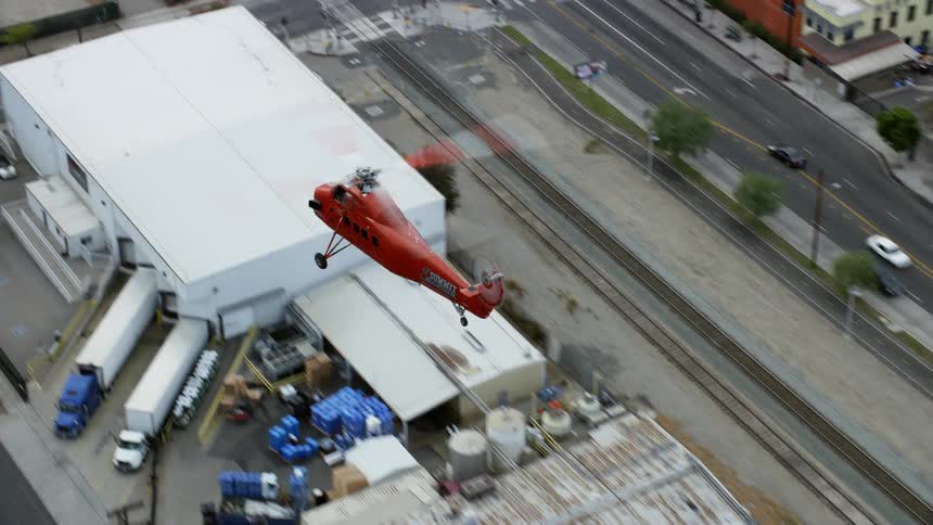 A Sikorsky S58T helicopter is tracked flying over the Pacoima area revealing the Whiteman Airport in California