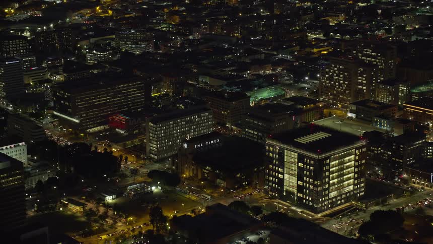 A thrilling shot of City Hall LAPD Headquarters and LA Times Building amid the dazzling night lights of downtown Los Angeles California