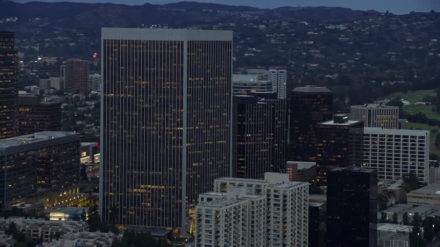An epic aerial shot of Century Plaza Towers at twilight featuring tall skyscrapers and superstructures in Century City California