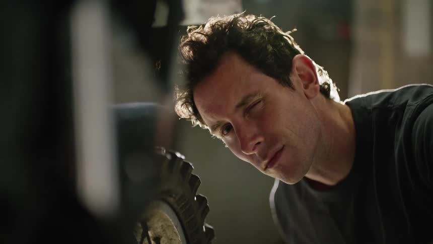 A mechanic is examining a tire
