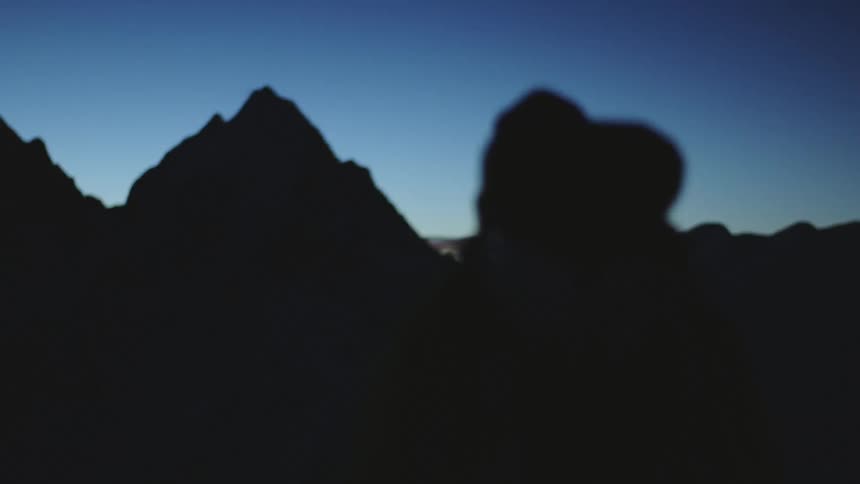 A person hikes towards the mountains