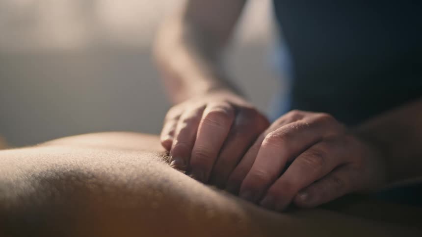 Someone is slowly giving another adult a back massage