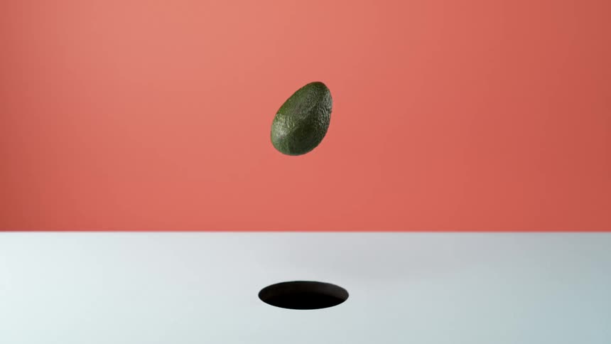 Avocado falls into abstract dark hole