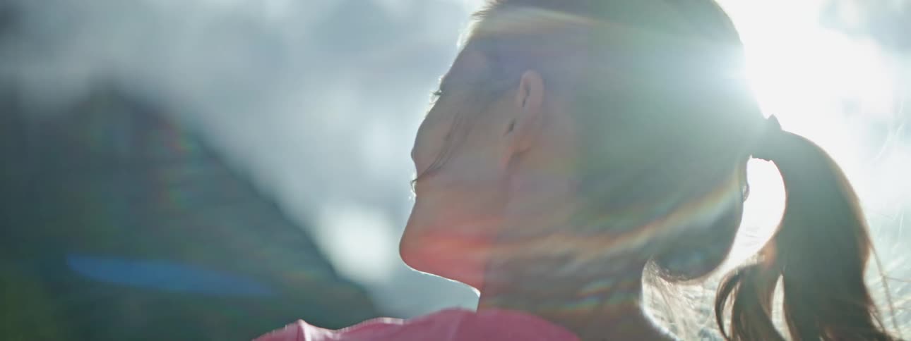 Serene Woman Contemplating with Sunlit Backdrop