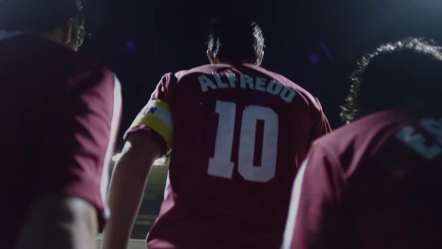 Three players walk into the stadium