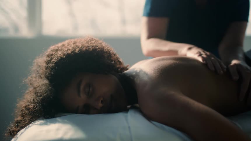 A womans back is massaged in a spa
