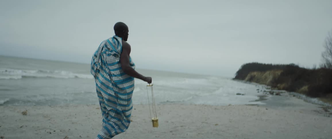 A man is walking on the beach by himself
