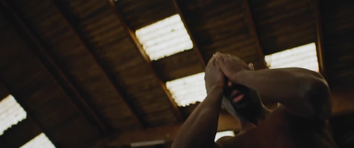 A man wipes his face with his hands