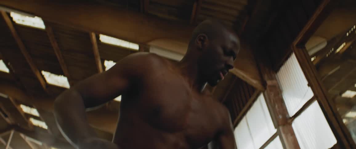 A man is cleaning an indoor building