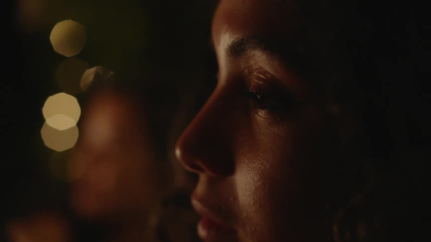 Close up view of a womans face is displayed at night