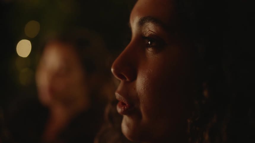 Two women are talking and sitting at a restaurant