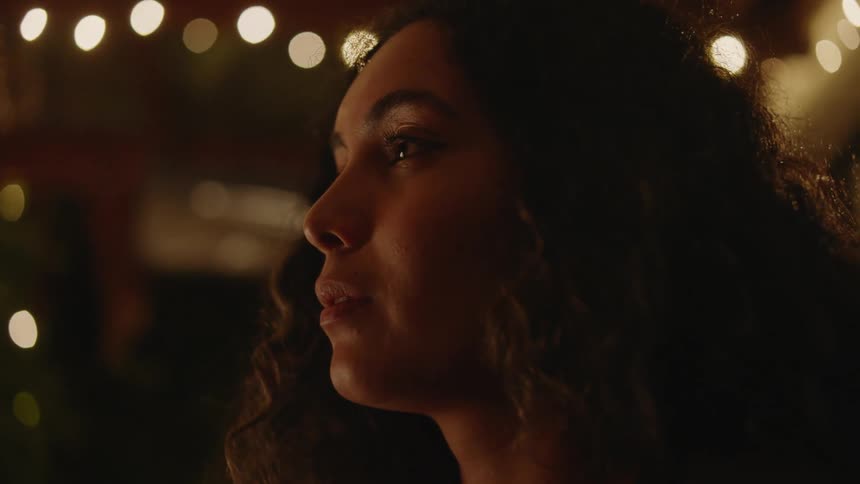 A woman is looking around outside