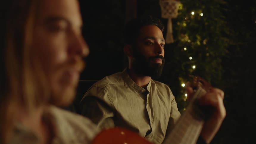 Two friends are playing a musical instrument together