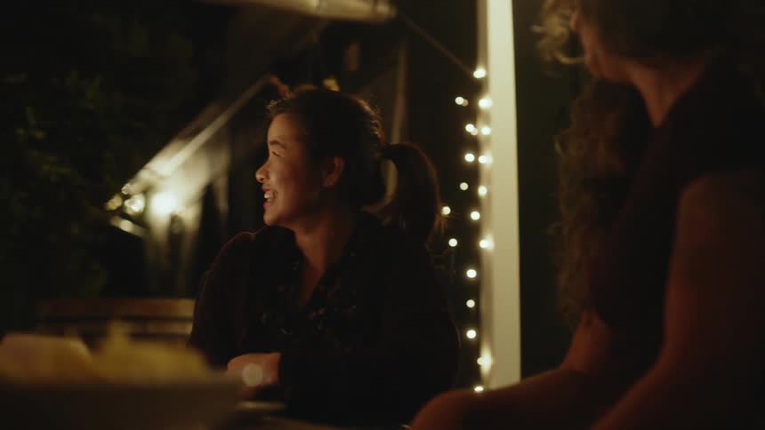 Two women are enjoying each others company chatting and laughing together in a friendly manner