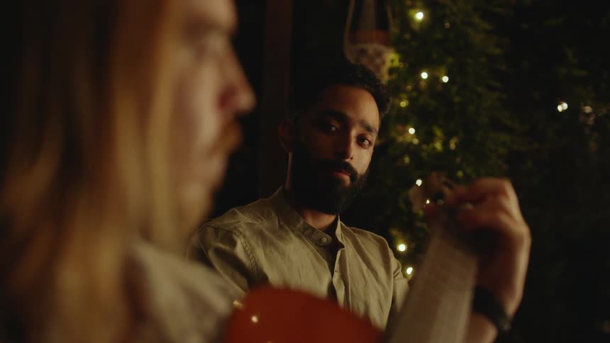 A man is playing guitar at night