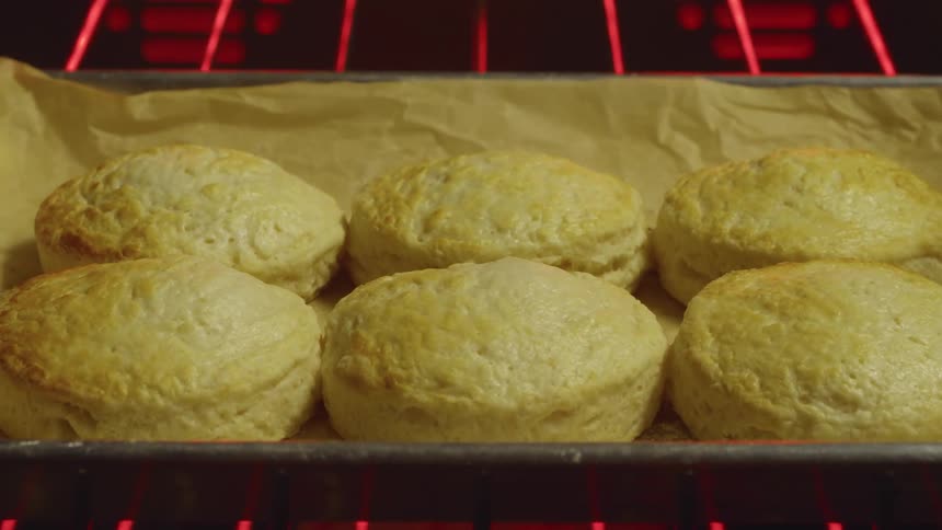 Biscuits on lined sheet pan bake in oven