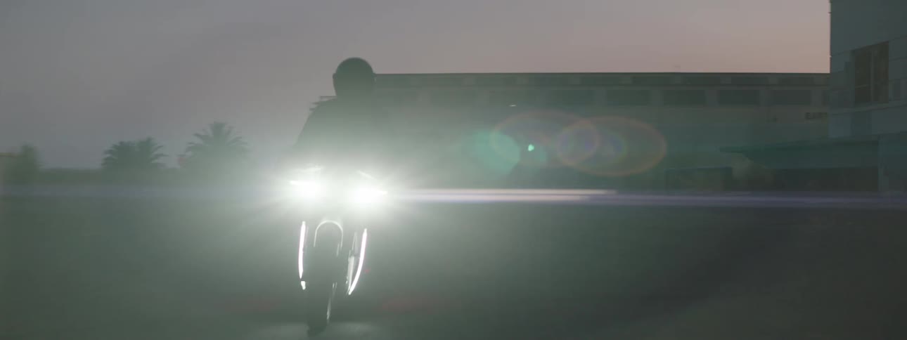 A man is riding a motorcycle during the night time