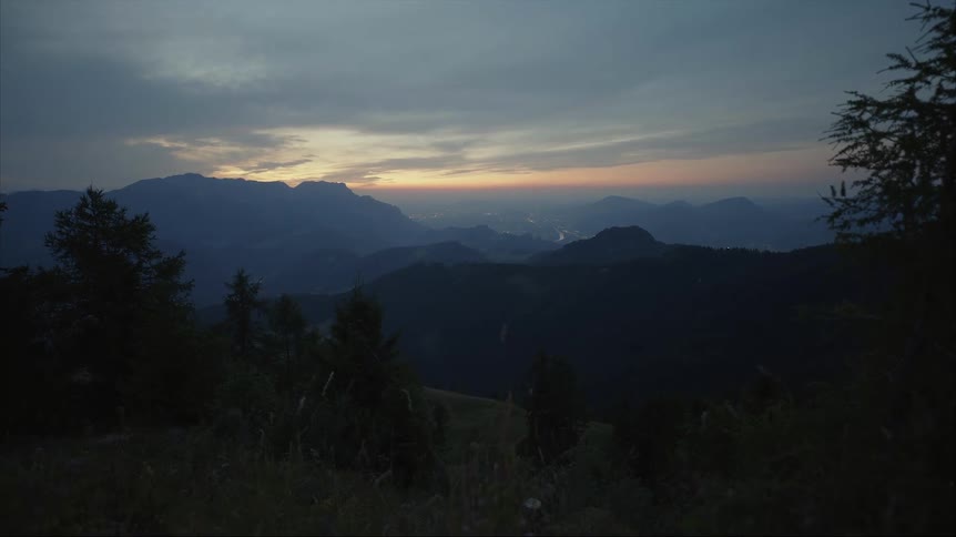 The sun is setting in the horizon of the landscape