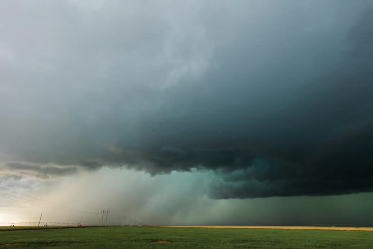 Dark clouds move over an open field