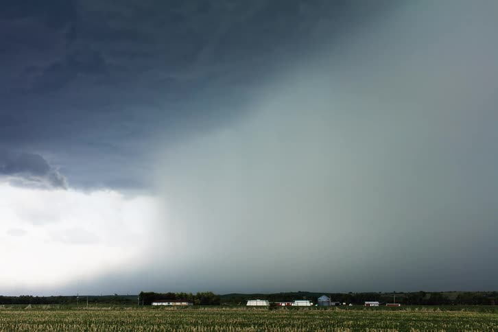 Dark clouds float in the sky over the countryside