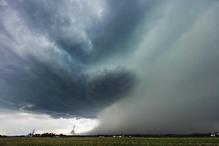 Dark clouds form over a farm