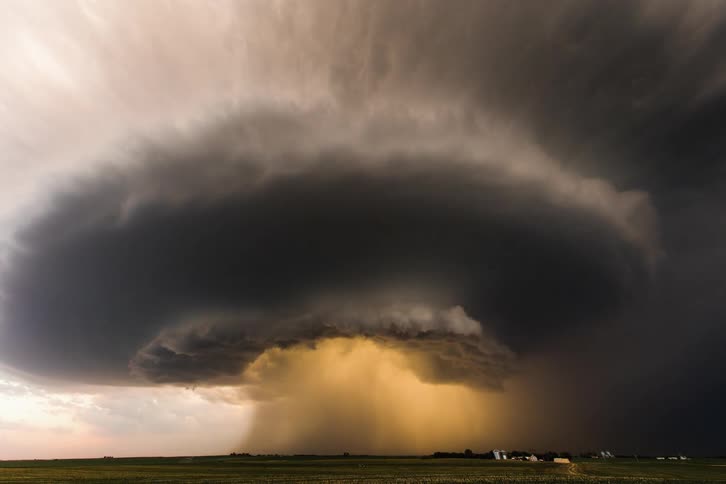 A large storm rolling and forming with a yellow dust cloud in the middle