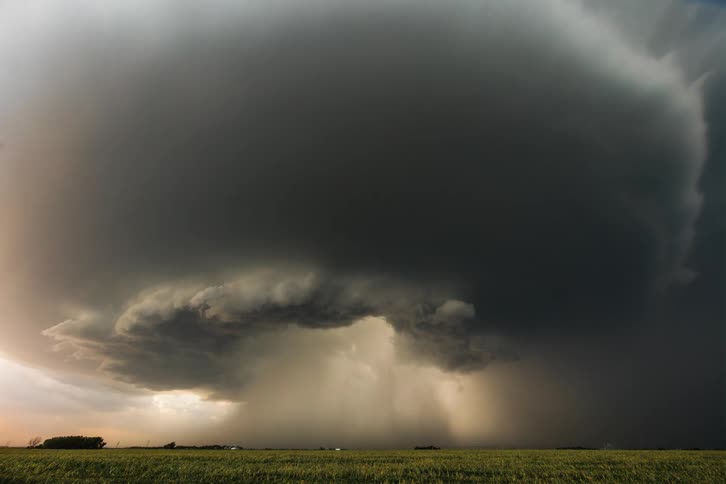 Large storm clouds spin and pour rain