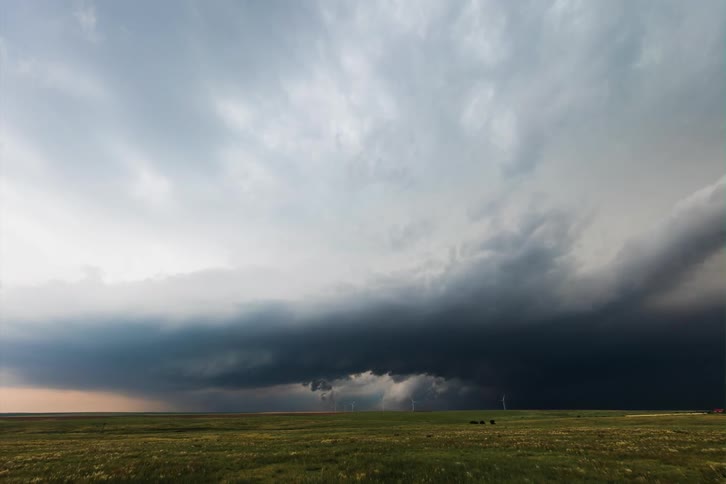 Storm cloud forms rotating center over fields