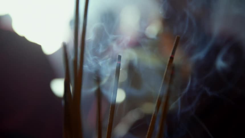 A group of monks with incense burning