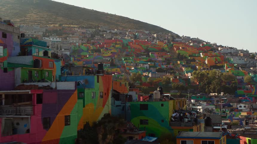 Colorful homes sit along the side of a hill
