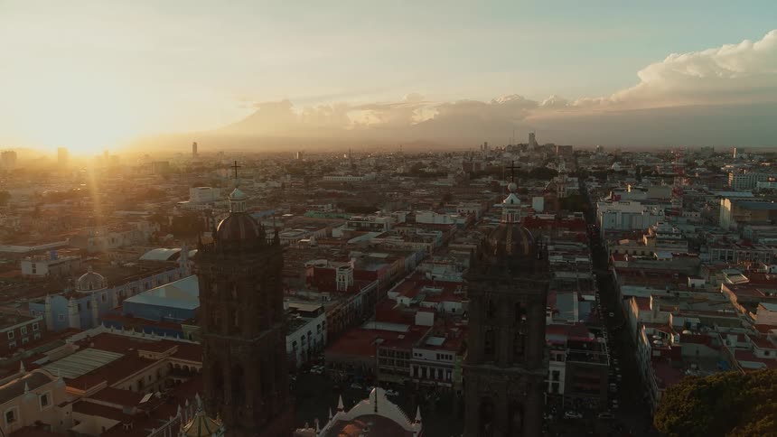 Tall buildings with crosses on top tower over a city