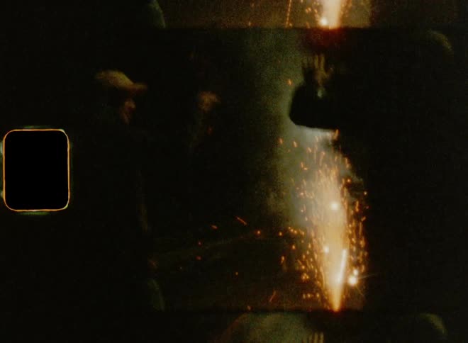 Young men lighting match cracker fireworks while dancing and cheering on the street on 8mm film