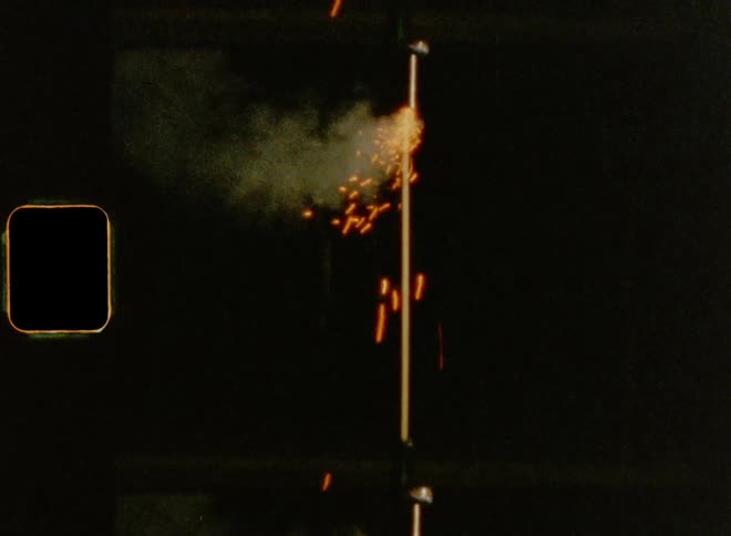 Fireworks rocket standing in glass bottle before it is launching up into the dark night sky on July 4th on Super 8mm film