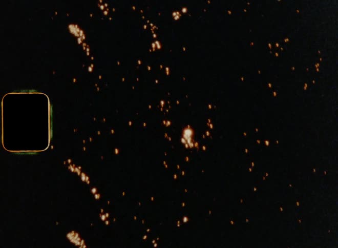 Close up of fireworks going off in the sky at night on 8mm film