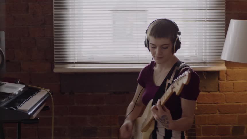 A girl is playing a guitar