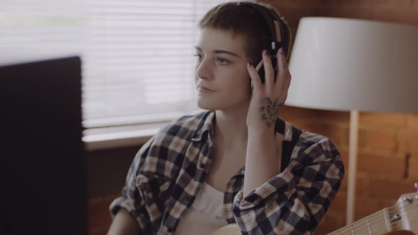 A woman is listening to headphones