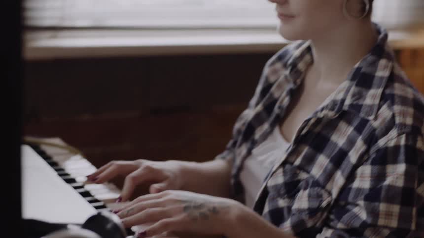 A woman is playing a keyboard