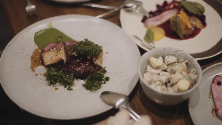 A person is eating food from plates