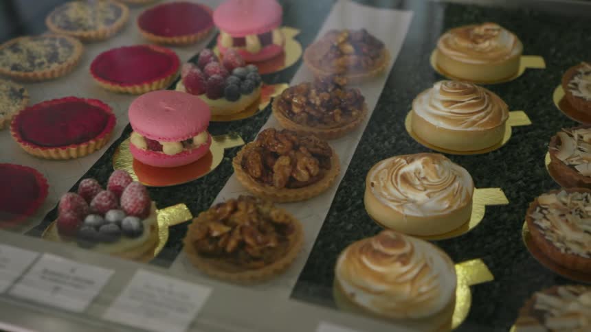 Various pastries sit inside a display case