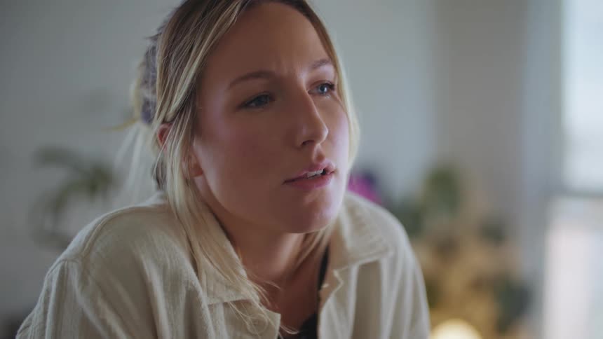 A woman thinks about something at home